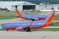 N211WN @ KSAT - Southwest B737 taxies to the holding point, while another reduces speed on the runway - by FBE