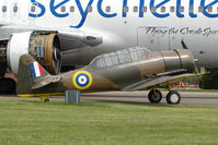 G-AZBN @ EGBP - 1942 Noorduyn AT-16 Harvard IIB , FT391 , - dwarfed by Air Seychelles B767 - at Kemble on Great Vintage Flying Weekend - by Terry Fletcher