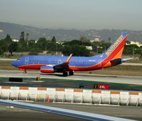 N442WN @ LAX - Southwest 2003 Boeing 737-7H4 in new colors w/winglets rolling on Runway 24L - by Steve Nation