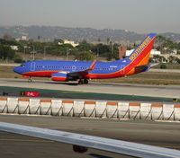 N909WN @ LAX - Southwest 2008 Boeing 737-7H4 in new colors w/winglets ready to rolling on RW 24L - by Steve Nation