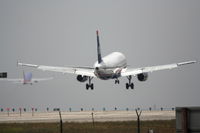 N667AW @ KLAX - US Airways Airbus A320-232, N667AW short final 24R KLAX, SouthWest 737 lifting off on 25L. - by Mark Kalfas