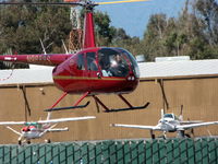 N9888S @ SQL - That's concentration! 2007 Robinson Helicopter Company R44 II @ San Carlos Muni, CA - by Steve Nation