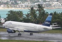 N637JB @ TNCM - landing on a wet day