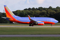 N708SW @ ORF - Southwest Airlines N708SW (FLT SWA1129) starting takeoff roll on RWY 23 enroute to Chicago Midway Int'l (KMDW). Seen here in the bright sun, but shadows all around. The clouds were passing across the sky.