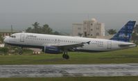 N599JB @ TNCM - Jet blue landing at TNCM on a wet day