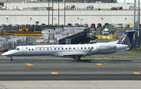 N13161 @ KEWR - Yet another CO ExpressJet taxies past cargo containers at Newark Airport. - by Daniel L. Berek