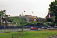 L1710 @ EGKB - Hawker Hurricane (replica).  full-scale replica Hawker Hurricane. Gate-guard outside the RAF Memorial Chapel at the former RAF Biggin Hill. - by Malcolm Clarke