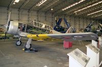 G-BTXI @ EGSU - Noorduyn AT-16 Harvard Mk2B. As FE695 of the Royal Air Force, undergoing maintenance in the 'active' hangar at the Imperial War Museum, Duxford in 1996. - by Malcolm Clarke