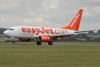 G-EZJX @ EGGW - Touching down as a brisk shower passes through. - by MikeP