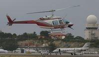 N695MC @ TNCM - N695MC crossing the main runway for landing at the helipad - by Daniel Jef