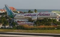9Y-ANU @ TNCM - Caribbean airlines 737 departing TNCM on runway 28 with an early gears up!!!