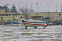 N855AE @ CID - Pulling out of the gate during light snow - by Glenn E. Chatfield