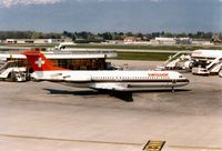 HB-IVE @ LSGG - Fokker 100 of Swissair at the terminal at Geneva in March 1994. - by Peter Nicholson