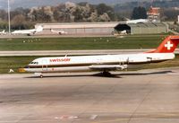 HB-IVG @ LSGG - Fokker 100 of Swissair at Geneva in March 1994. - by Peter Nicholson