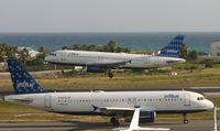 N506JB @ TNCM - Jet Blue N506JB Landing at TNCM while Jet BLue N709JB hold at THE holding point ALpha for take off - by Daniel Jef