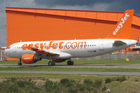 G-EZTI @ EGGW - Easyjet A320 taxies past base hangar - by Terry Fletcher
