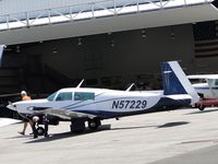 N57229 @ POC - Pilot pre-flight checking aircraft parked at Howard Aviation - by Helicopterfriend