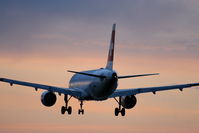 HB-IJI @ EGLL - Swiss Airbus A320 landing into the sunset on RW 27R at Heathrow - by Chris Hall