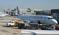 C-FEJP @ KORD - At rest at ORD, with a brother departing in the background. - by Daniel L. Berek