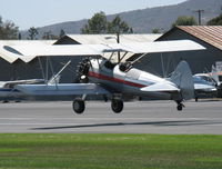 N65124 @ SZP - 1943 Boeing Stearman A75N1 'Spirit of OPEC', P&W R-985 Wasp Jr. (by Jacobs) 450 Hp upgrade, square wingtips, Restr. Exper. class, takeoff climb Rwy 22 - by Doug Robertson