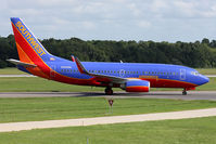 N935WN @ ORF - Southwest Airlines N935WN (FLT SWA1788) taxiing to Gate A3 via taxiway Charlie after arrival on RWY 5 from Orlando Int'l (KMCO). Note the Free Bags Fly Here sticker that was recently added to the right side of the aircraft. - by Dean Heald