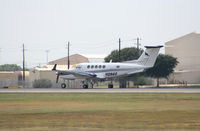 N128AS @ KAUS - Raytheon/Beech departs 17L. - by Darryl Roach