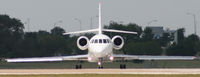 N1128B @ KAUS - Falcon lines up 17L. - by Darryl Roach