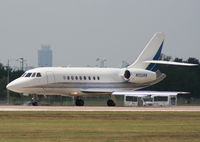 N1128B @ KAUS - Falcon departs 17L. - by Darryl Roach