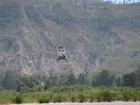 N1560X @ SZP - 2006 Schweizer 269C-1(300CB), Lycoming HIO-360-G1A 180 Hp, departure climb from SZP's helipad over river route - by Doug Robertson