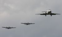 N283SA @ YIP - Falcon 20 landing with two B-17s in formation in background