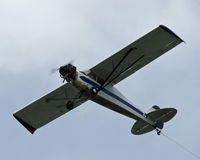 N96920 - An old Taylorcraft struggles against the wind as it tows a giant banner over Cape Cod. - by Daniel L. Berek