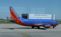 N327SW @ KDEN - Sorry for the window glare. Southwest Airlines Boeing 737-300 taxiing to the runway.