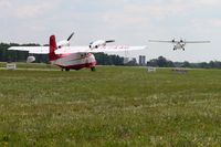 N744G @ OSH - Airventure 2010 - Oshkosh, Wisconsin, with N222FT landing in the background. - by Bob Simmermon