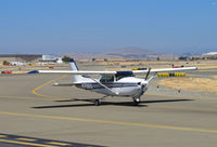 N7561X @ KCCR - Locally-based 1977 Cessna R182 approaching public viewing area at Buchanan Field - by Steve Nation