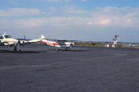 N57BW @ KFCM - Partial shot on the left of N9468D. FCM VOR is visible on the right behind the Mobil sign. Classic Aviation.