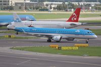PH-EZI @ EHAM - KLM cityhopper taxiing in with a queue of departures behind