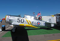 N4763 @ KRTS - Race #50 AT-6C in Royal Canadian Navy with yellow colors and Abracadabra nose art in T-6 Class pits @ 2009 Reno Air Races - by Steve Nation