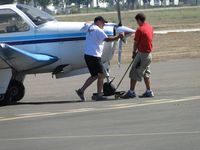 N9019S @ POC - Notice front wheel is not straight and pilot is being assisted by Brackett personnel to move the ship and open runway 26L - by Helicopterfriend