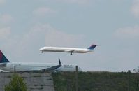 N907DL @ ATL - A Delta Boeing MD-88 over the numbers for Rwy 27R@ATL as a Delta Boeing 757-251, N557NW holds #1 for departure. The B757 once wore NW Airlines livery colors.  (an f-stop 5.6 photograph) - by Bill Thornton, former managing Editor USAF Flying Safety Magazine