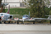 N-MATS @ KMKE - Obiously wearing a fictitious registration, this derelict Cessna occupies a backlot with other retired military planes. - by Daniel L. Berek
