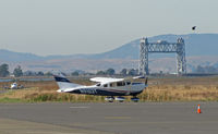 N9163T @ KAPC - Brand new Bridgeford FS Cessna T206H taxiing out for takeoff with Napa River RR bridge, hawk and arriving Cessna 421 in background - by Steve Nation