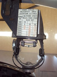66-15185 @ ALO - Here is the XM-60 reflex sight for aiming the rockets.  They were pretty accurate.  I used to hit a five foot target from 1500' and 80 knots IAS with ease. - by Bookie