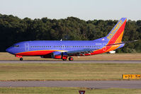 N343SW @ ORF - Southwest Airlines N343SW (FLT SWA1384) rolling out on RWY 5 after arrival from Orlando Int'l (KMCO). The Airport Operations truck in the background is trying to rid the area of flocks of seagulls (non-lethal methods) that are posing a threat to aircraft. - by Dean Heald