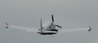 N26RG @ CCB - Headed westbound on a very cloudy day - by Helicopterfriend