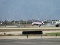 N450AA @ ONT - Wheels smoke at touch down on runway 26R - by Helicopterfriend