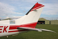 G-SEEK @ X5FB - A tail close-up showing the map of this Cessna T210N's world travels. - by Malcolm Clarke