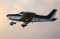 G-BCJM @ EGFH - Piper Cherokee departing at dusk for a local flight - by Roger Winser