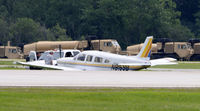 N8159B @ KOSH - Ran off runway on landing due to damage on port main tire caused by propeller strike from another aircraft while on approach to Oshkosh, other aircraft landed safely. - by Todd Royer