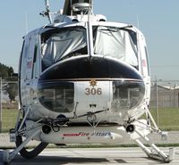 N306SB @ 3601 - Eyes covered up from the sun, Fire Attack tank is approximately 350 - 400 gallons. Note SBSO insignia on nose. Parked at Prado Helitack Base - by Helicopterfriend