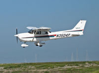 N3504P @ KSQL - Locally-based 2001 Cessna 172R nears touchdown with power lines and SF Bay in background @ San Carlos, CA - by Steve Nation